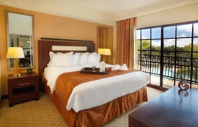 a hotel room with a large bed and a balcony at Marbrisa Carlsbad Resort in Carlsbad