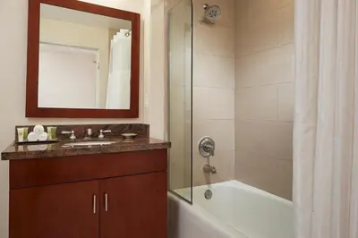a bathroom with a tub and a sink and a shower at Marbrisa Carlsbad Resort in Carlsbad