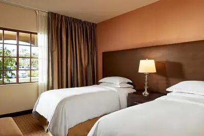 a hotel room with two beds and a window at Marbrisa Carlsbad Resort in Carlsbad