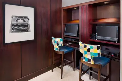a room with two chairs and a desk with two televisions at Residence Inn by Marriott San Diego Downtown/Gaslamp Quarter in San Diego