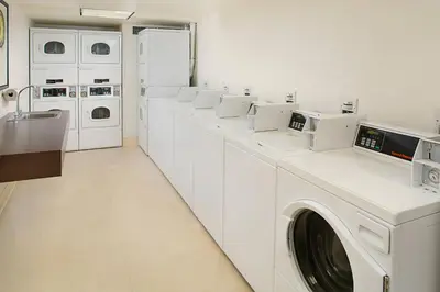 a white laundry room with a washer and dryer at Residence Inn by Marriott San Diego Downtown/Gaslamp Quarter in San Diego