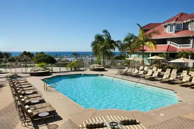 a swimming pool with lounge chairs and a resort at Laguna Cliffs Marriott Resort & Spa in Dana Point