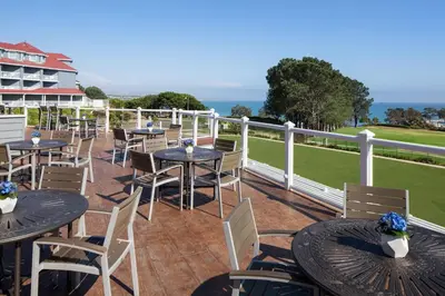 a patio with tables and chairs and the ocean at Laguna Cliffs Marriott Resort & Spa in Dana Point