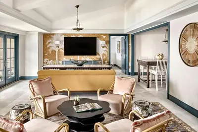 a living room with a tv and a table and chairs at The Ritz-Carlton, Laguna Niguel in Dana Point