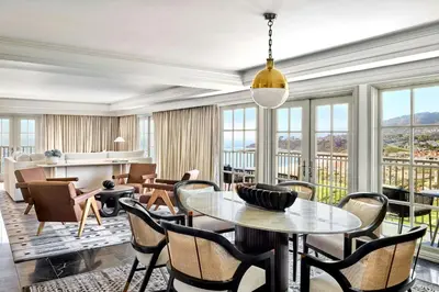 a living room with a table and chairs and windows at The Ritz-Carlton, Laguna Niguel in Dana Point