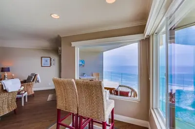 a living room with a view of the ocean at Work Friendly Oceanfront SURF25 Condo in Solana Beach