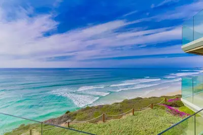 a view of the ocean from the balcony of a house at Work Friendly Oceanfront SURF25 Condo in Solana Beach
