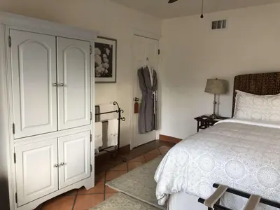 a bedroom with a bed and a closet and a dresser at Kate Stanton Inn in Encinitas