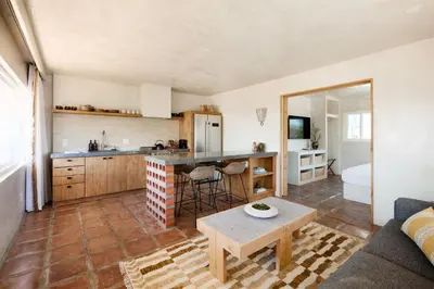 a kitchen and living room with a table and a couch at Los Bungalows in Imperial Beach