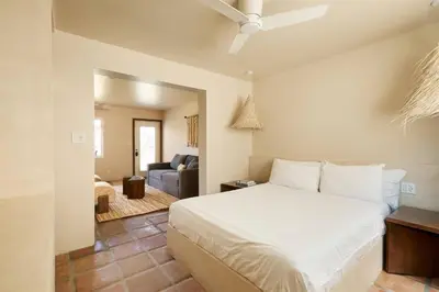 a bedroom with a bed and a living room at Los Bungalows in Imperial Beach
