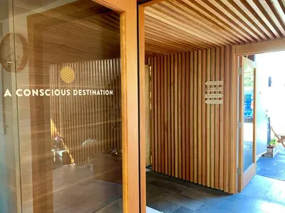 a glass door of a house with aocratesitution sign on it at Inn at Moonlight Beach in Encinitas
