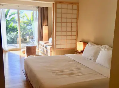 a bedroom with a bed and a large window at Inn at Moonlight Beach in Encinitas