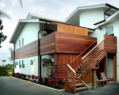 a house with a wooden staircase in front of it at Inn at Moonlight Beach in Encinitas