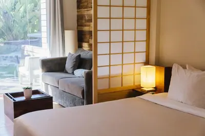 a hotel room with a bed and a couch at Inn at Moonlight Beach in Encinitas