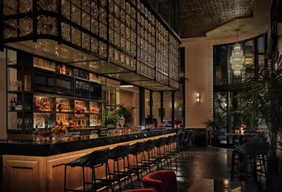 a restaurant with a bar with stools at Pendry San Diego in San Diego