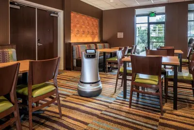 a restaurant with tables and chairs and a trash can at Fairfield Inn & Suites by Marriott San Diego North/San Marcos in San Marcos