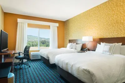 a hotel room with two beds and a television at Fairfield Inn & Suites by Marriott San Diego North/San Marcos in San Marcos