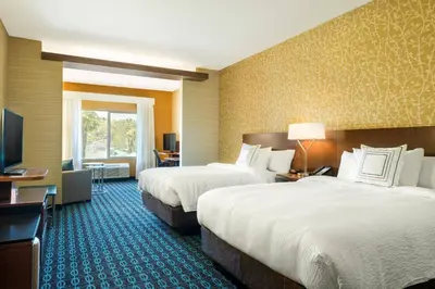 a hotel room with two beds and a television at Fairfield Inn & Suites by Marriott San Diego North/San Marcos in San Marcos