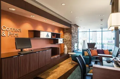 a lobby with a waiting room with a computer and chairs at Fairfield Inn & Suites by Marriott San Diego North/San Marcos in San Marcos