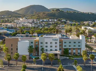 an aerial view of a hotel with palm trees at Fairfield Inn & Suites by Marriott San Diego North/San Marcos in San Marcos