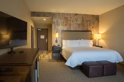 a hotel room with a bed and a flat screen tv at Hampton Inn & Suites Murrieta Temecula in Murrieta