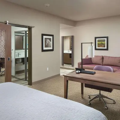 a hotel room with a bed and a couch at Hampton Inn & Suites Murrieta Temecula in Murrieta