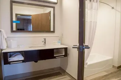 a bathroom with a sink and a tub and a mirror at Hampton Inn & Suites Murrieta Temecula in Murrieta