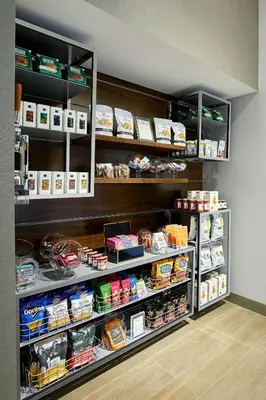 a store shelf with food and other food items at AC Hotel by Marriott Irvine in Irvine