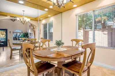 a dining room with a wooden table and chairs at The Shangri-La of La Jolla in San Diego