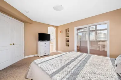 a bedroom with a white bed and a tv at The Shangri-La of La Jolla in San Diego