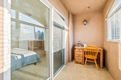 a bedroom with a bed and a desk and a window at The Shangri-La of La Jolla in San Diego