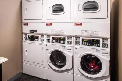 a stack of white washers and dryers in a room at Courtyard by Marriott Temecula Murrieta in Murrieta