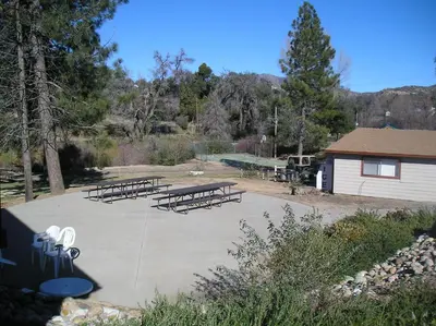 a group of picnic tables in a park at Oakzanita Springs Camping Resort Cabin 1 in Descanso