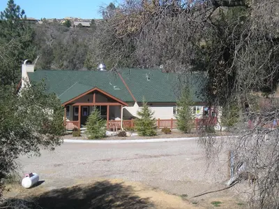 a house with a green roof and a yard at Oakzanita Springs Camping Resort Cabin 1 in Descanso