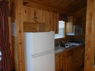 a kitchen with a white refrigerator and a sink at Oakzanita Springs Camping Resort Cabin 1 in Descanso