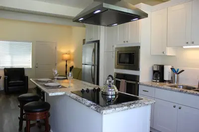 a kitchen with a sink and a counter top at Seaside Village Carlsbad in Carlsbad
