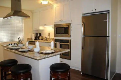 a kitchen with a large stainless steel refrigerator at Seaside Village Carlsbad in Carlsbad