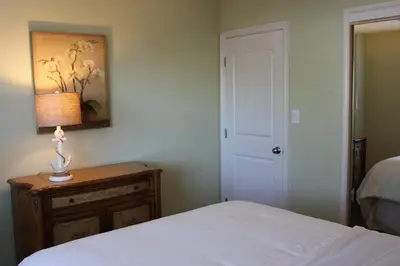 a bedroom with a bed and a table with a lamp at Seaside Village Carlsbad in Carlsbad
