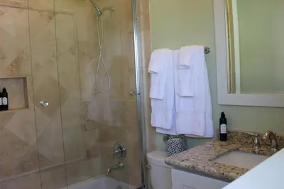 a bathroom with a shower and a toilet and a sink at Seaside Village Carlsbad in Carlsbad