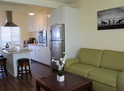 a kitchen and living room with a couch and a refrigerator at Seaside Village Carlsbad in Carlsbad