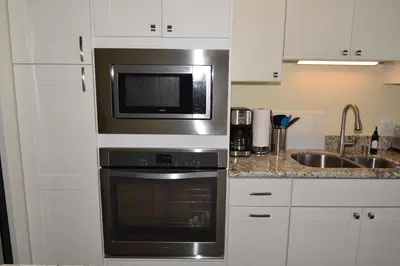 a kitchen with a microwave and a sink at Seaside Village Carlsbad in Carlsbad