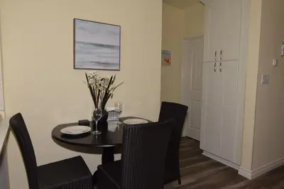a dining room with a table and chairs and a table and chairsktop at Seaside Village Carlsbad in Carlsbad
