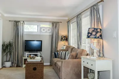 a living room with a couch and a tv at La Jolla Cottage in San Diego