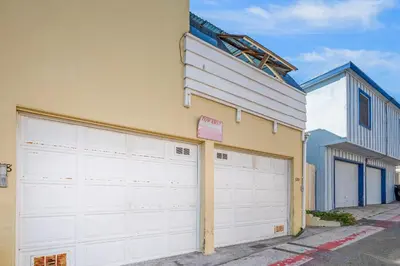 two white garage doors in front of a building at Mike's Place at the Beach in San Diego