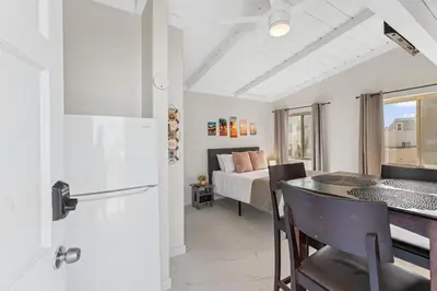 a kitchen and living room with a bed and a table at Sweet Sunset Studio in San Diego