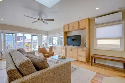 a living room with a couch and a tv at Beach Park Getaway in San Diego