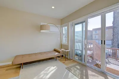a living room with a bench and a balcony at Beach Park Getaway in San Diego