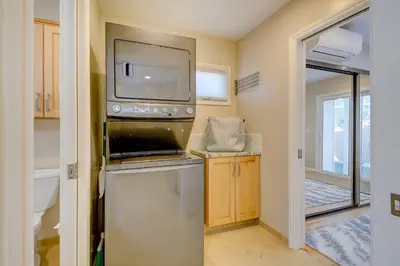 a kitchen with a dishwasher and a tv on the wall at Beach Park Getaway in San Diego