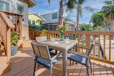 a wooden deck with a table and two chairs at Beach Park Getaway in San Diego