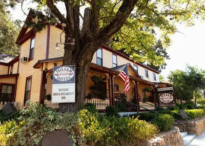 a inn with a sign in front of a tree at Julian Gold Rush Hotel in Julian